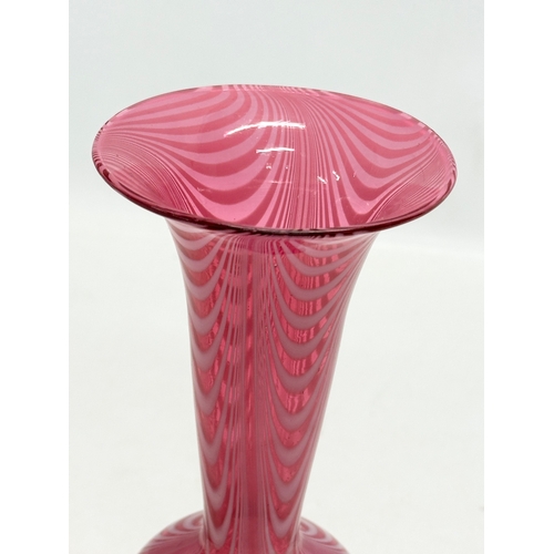 43 - A cranberry glass vase, with opalescent feathered ripples and cornet shaped rim. Italian, Empoli sty... 