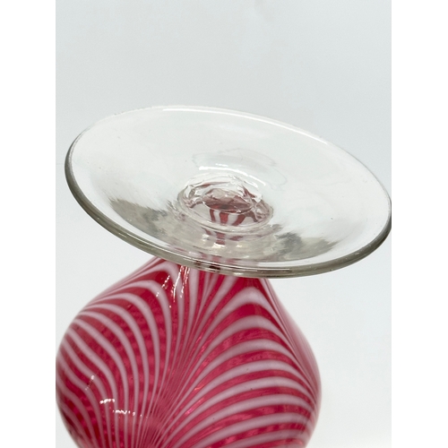 43 - A cranberry glass vase, with opalescent feathered ripples and cornet shaped rim. Italian, Empoli sty... 