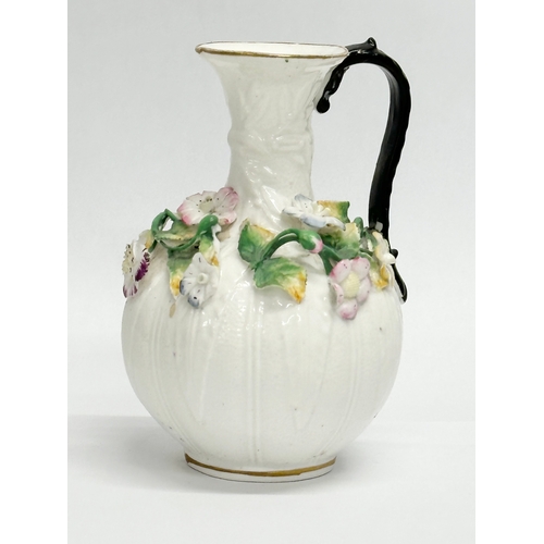 122 - A 19th Century Victorian flower encrusted jug. 9x14cm