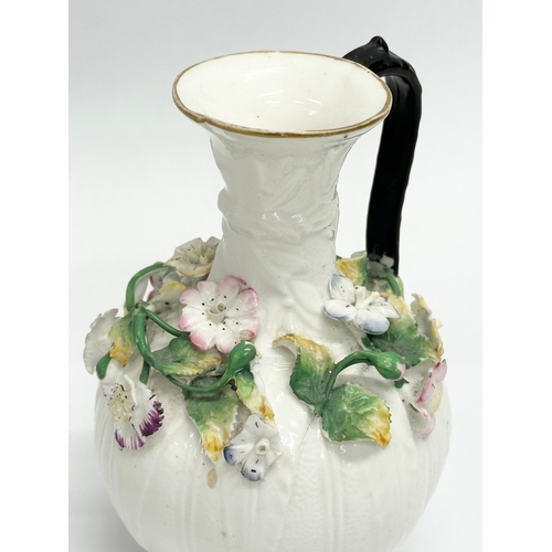 122 - A 19th Century Victorian flower encrusted jug. 9x14cm