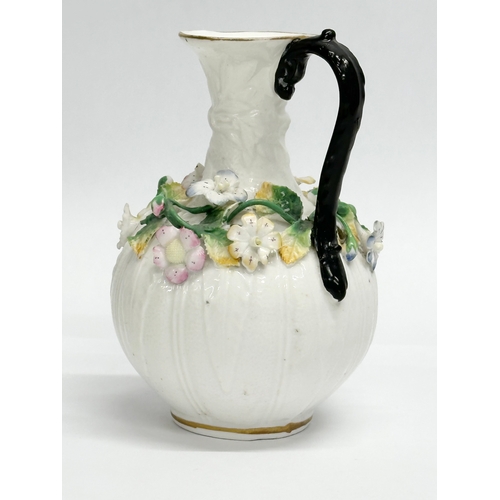 122 - A 19th Century Victorian flower encrusted jug. 9x14cm