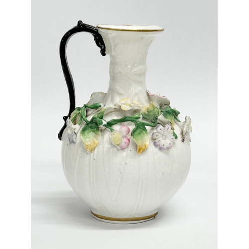 122 - A 19th Century Victorian flower encrusted jug. 9x14cm