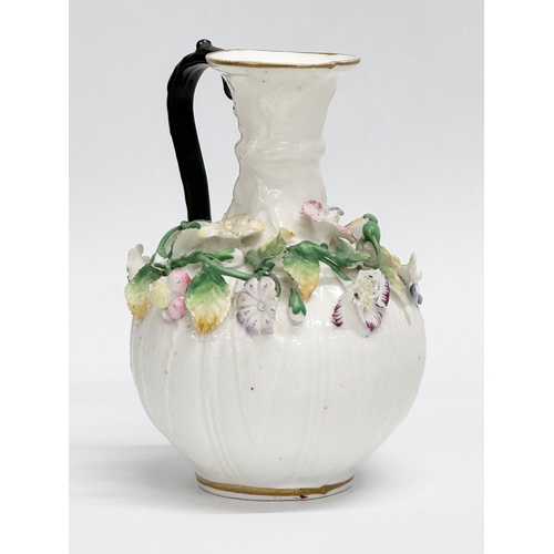 122 - A 19th Century Victorian flower encrusted jug. 9x14cm