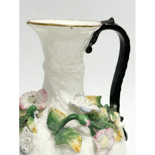 122 - A 19th Century Victorian flower encrusted jug. 9x14cm