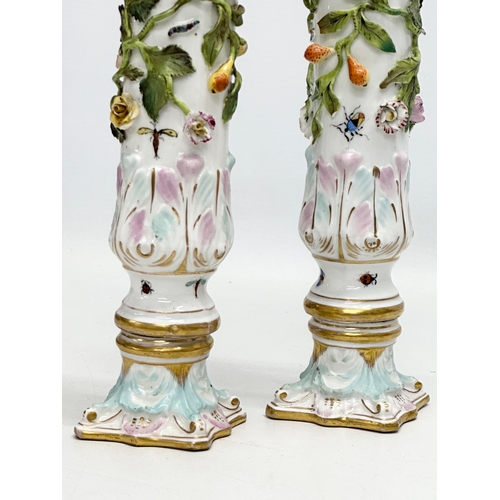 121 - A pair of Early 19th Century flower encrusted spill vases, decorated with insects on Corinthian styl... 