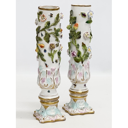 121 - A pair of Early 19th Century flower encrusted spill vases, decorated with insects on Corinthian styl... 