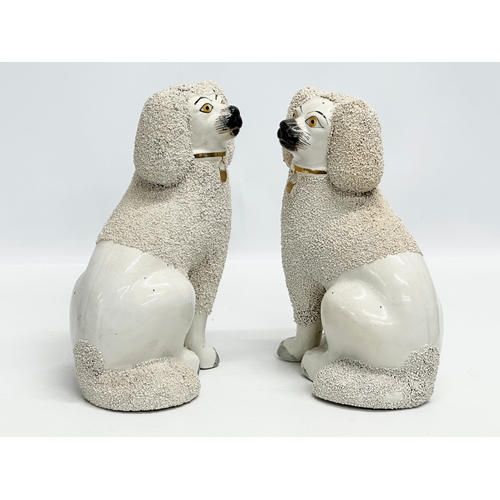 94 - A pair of 19th Century Victorian Staffordshire Pottery dogs. 18x24cm