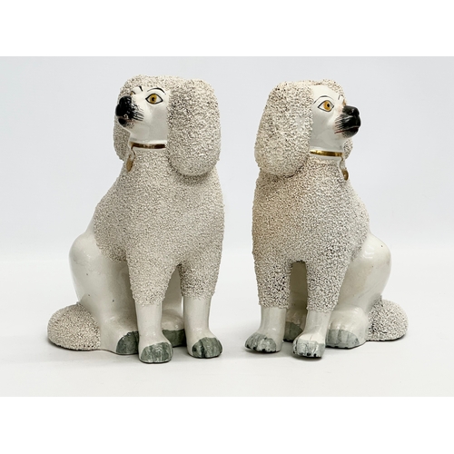 94 - A pair of 19th Century Victorian Staffordshire Pottery dogs. 18x24cm