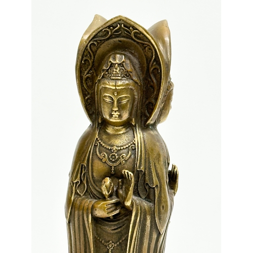 67 - A Chinese bronze 3 body Guanyin Buddha statue. Raised on a lotus leaf base. 4 character mark. 25cm