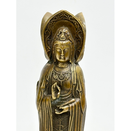 67 - A Chinese bronze 3 body Guanyin Buddha statue. Raised on a lotus leaf base. 4 character mark. 25cm