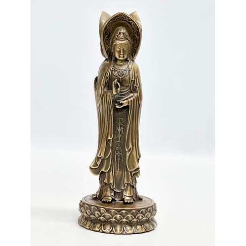 67 - A Chinese bronze 3 body Guanyin Buddha statue. Raised on a lotus leaf base. 4 character mark. 25cm