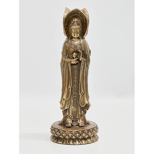 67 - A Chinese bronze 3 body Guanyin Buddha statue. Raised on a lotus leaf base. 4 character mark. 25cm