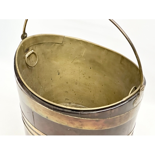 27 - A Late 18th Century George III mahogany and brass bound peat bucket, with original brass liner. Circ... 