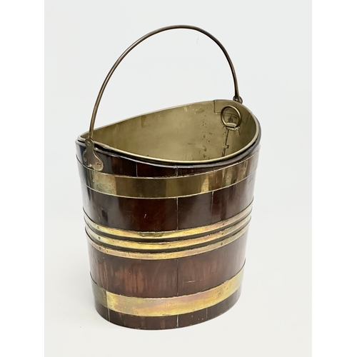 27 - A Late 18th Century George III mahogany and brass bound peat bucket, with original brass liner. Circ... 