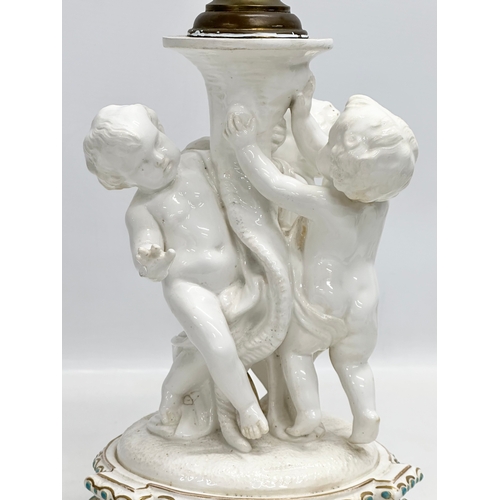 83 - A Late 19th Century Italian 3 putti table lamp, with a serpentine style column on a 2 tier gilt and ... 