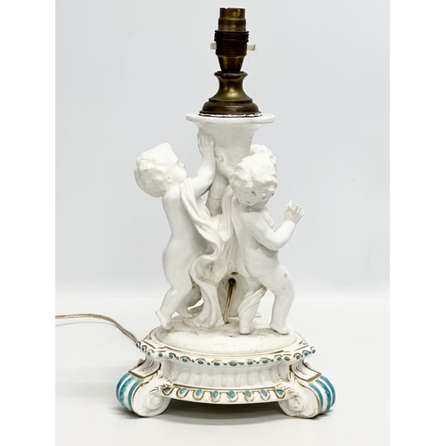 83 - A Late 19th Century Italian 3 putti table lamp, with a serpentine style column on a 2 tier gilt and ... 