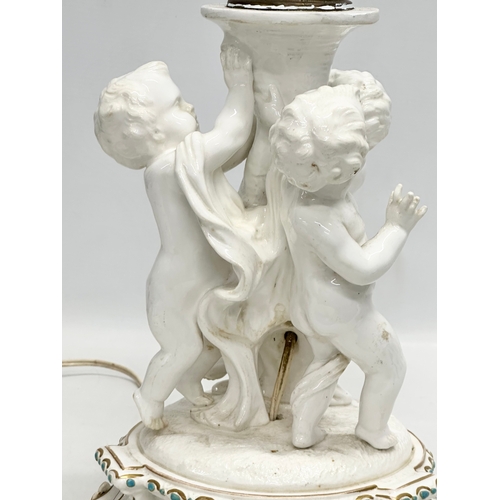 83 - A Late 19th Century Italian 3 putti table lamp, with a serpentine style column on a 2 tier gilt and ... 