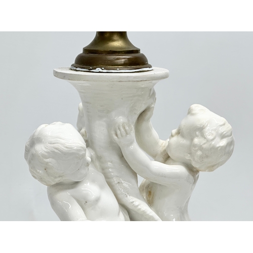 83 - A Late 19th Century Italian 3 putti table lamp, with a serpentine style column on a 2 tier gilt and ... 