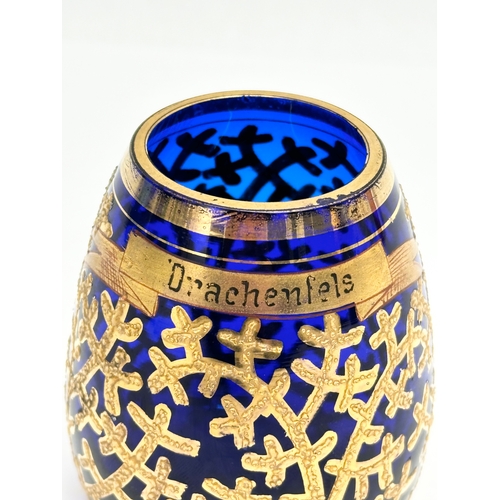 133 - A small Early/Mid 20th Century German gilt enamel bound cobalt blue glass vase. Drachenfels. 6x8cm