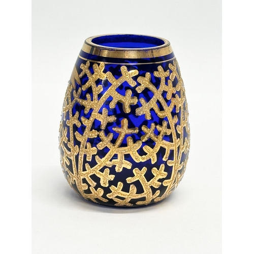 133 - A small Early/Mid 20th Century German gilt enamel bound cobalt blue glass vase. Drachenfels. 6x8cm