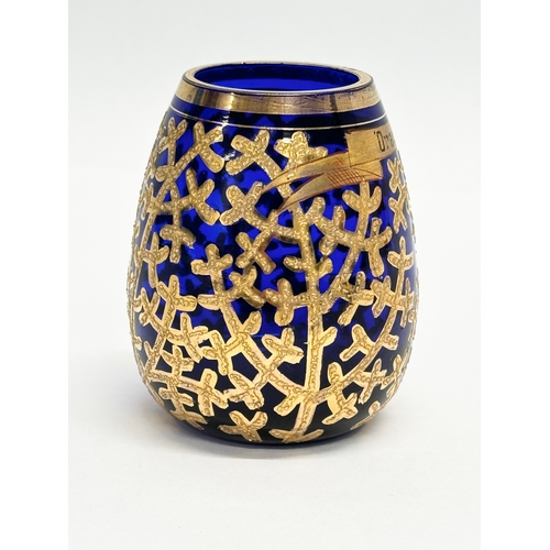 133 - A small Early/Mid 20th Century German gilt enamel bound cobalt blue glass vase. Drachenfels. 6x8cm