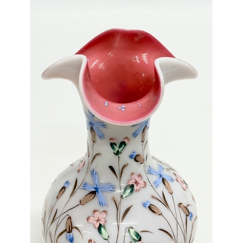 134 - A Late 19th Century hand painted enamel opaline glass vase, with pink interior and ripple curved rim... 