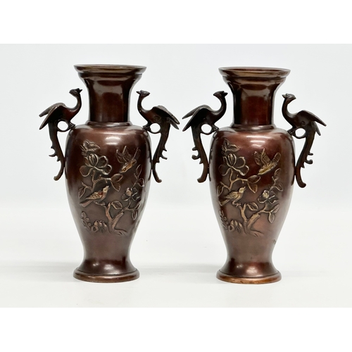 72 - A pair of Late 19th Century Japanese bronze baluster vases, with embossed birds in flight, trees and... 