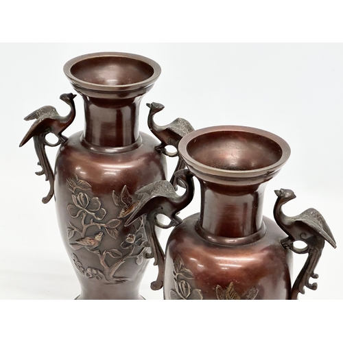 72 - A pair of Late 19th Century Japanese bronze baluster vases, with embossed birds in flight, trees and... 