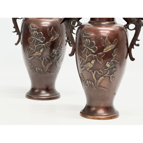 72 - A pair of Late 19th Century Japanese bronze baluster vases, with embossed birds in flight, trees and... 