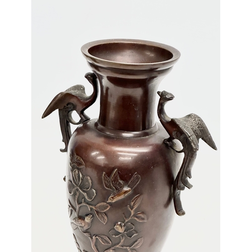 72 - A pair of Late 19th Century Japanese bronze baluster vases, with embossed birds in flight, trees and... 