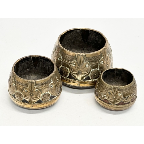 69 - A set of three 19th Century Indian brass bound ceremonial bowls. Raj Period (1858-1914). 11x8cm. 9x7... 