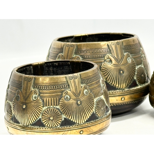 69 - A set of three 19th Century Indian brass bound ceremonial bowls. Raj Period (1858-1914). 11x8cm. 9x7... 