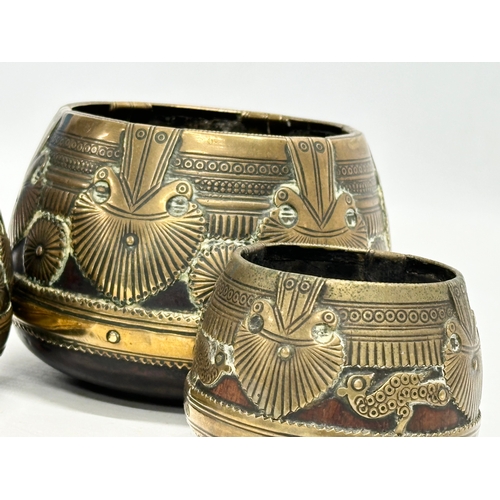 69 - A set of three 19th Century Indian brass bound ceremonial bowls. Raj Period (1858-1914). 11x8cm. 9x7... 