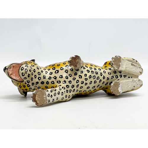 73 - A pair of 20th Century Indian painted wooden leopards. 26cm