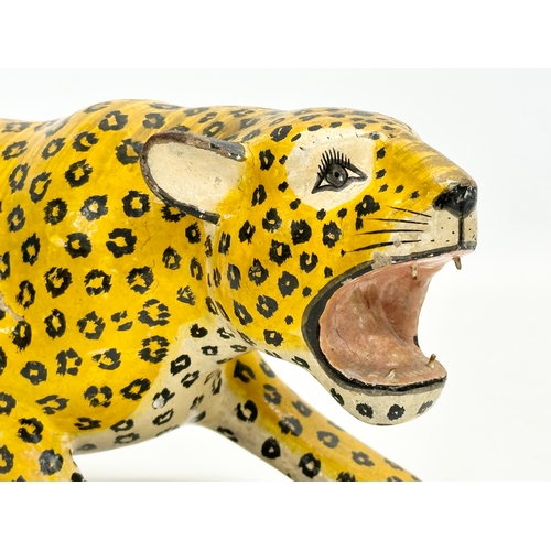 73 - A pair of 20th Century Indian painted wooden leopards. 26cm