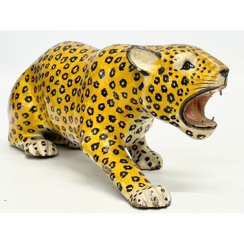 73 - A pair of 20th Century Indian painted wooden leopards. 26cm