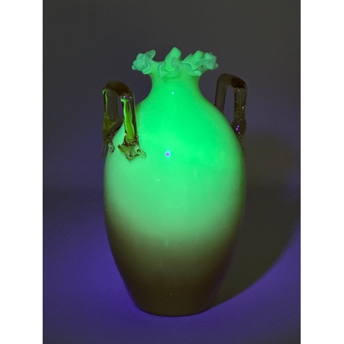 136 - A Late 19th Century Bohemian, uranium and opaline glass vase, with amber glass handle and flared rim... 