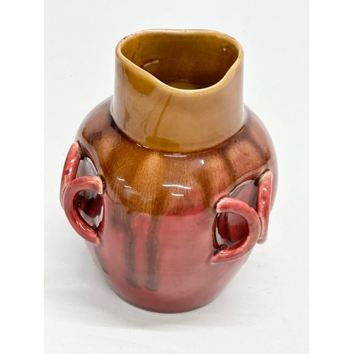 137 - A small Chinese Late 19th Century flambé and café-au-lait glazed, 3 handle drip pot. 9x9x12cm.