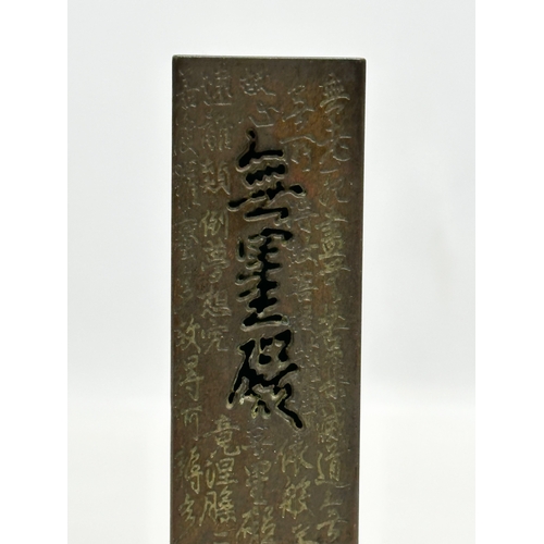 181 - A Chinese bronze stick incense burner. 13.5cm