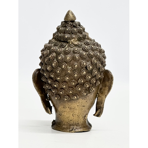 75 - An 18th/Early 19th Century Sino-Tibetan bronze Buddha head. 16cm