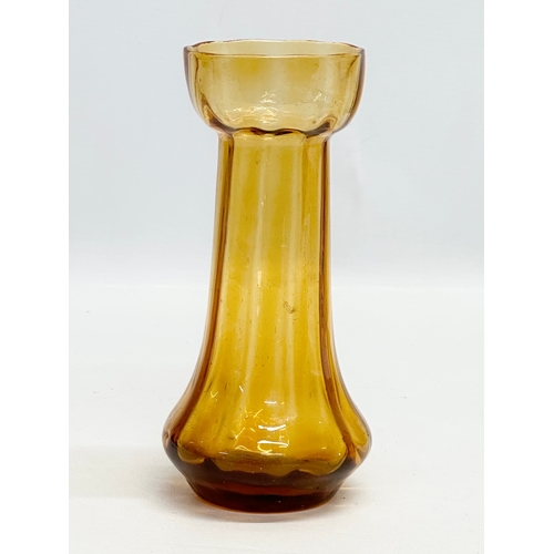 261 - Four Early 20th Century amber glass hyacinth vases. 20cm. 19.5cm. 18.5cm.