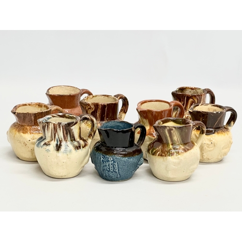 204 - A collection of nine 19th Century miniature glazed jugs. With all matching moulded relief design. Bi... 