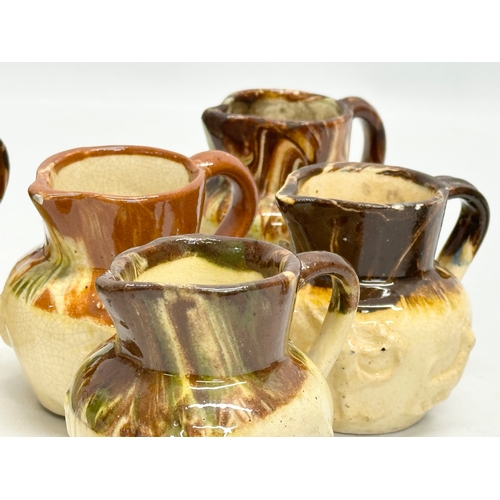 204 - A collection of nine 19th Century miniature glazed jugs. With all matching moulded relief design. Bi... 