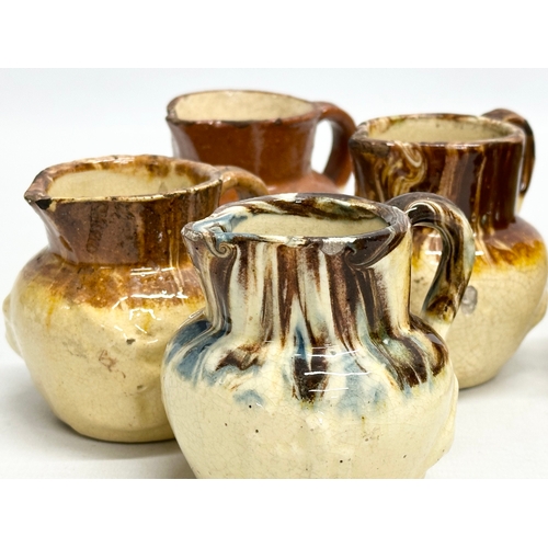 204 - A collection of nine 19th Century miniature glazed jugs. With all matching moulded relief design. Bi... 