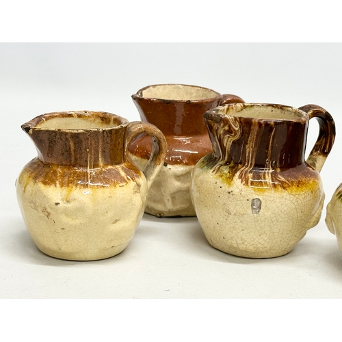 204 - A collection of nine 19th Century miniature glazed jugs. With all matching moulded relief design. Bi... 