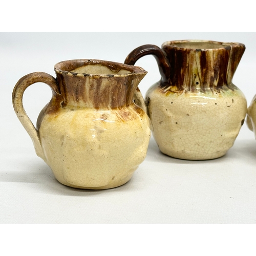 204 - A collection of nine 19th Century miniature glazed jugs. With all matching moulded relief design. Bi... 