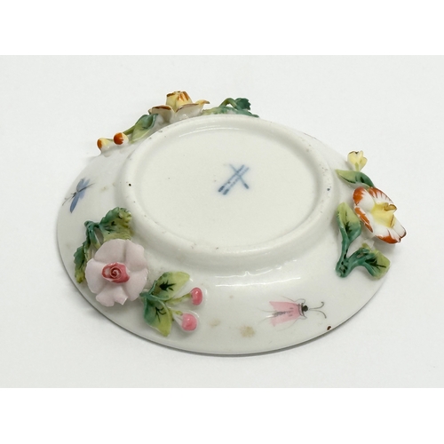 141 - Sitzendorf. A Late 19th/Early 20th Century German flower encrusted miniature cup and saucer, with pa... 