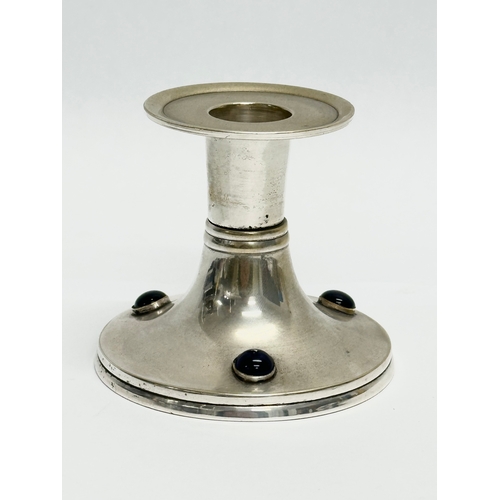 142 - An Early 20th Century Arts & Crafts silver plated candlestick. 8.5x7.5cm