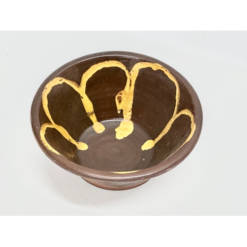 330 - An Irish Coalisland slip ware dairy bowl. 31x14cm