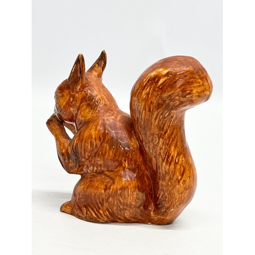 82 - A Late 19th/Early 20th Century pottery squirrel.  13x14cm